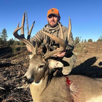 Hunter with whitetail buck in Black Hills